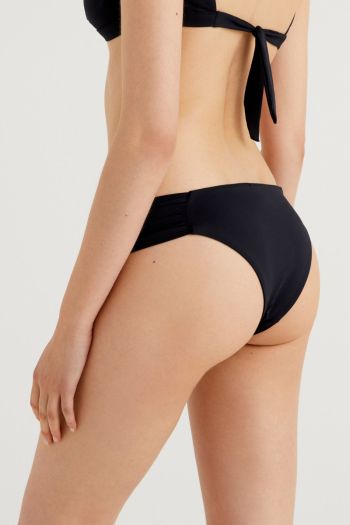Woman curled side sea briefs